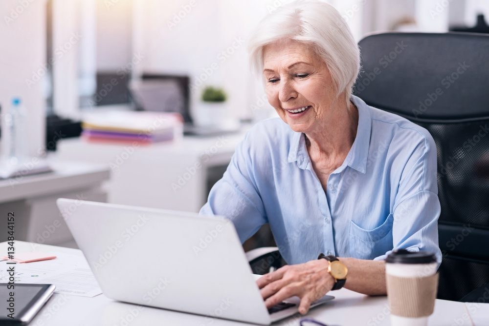 Smiling aged businesswoman working in the office Smiling aged businesswoman working in the office