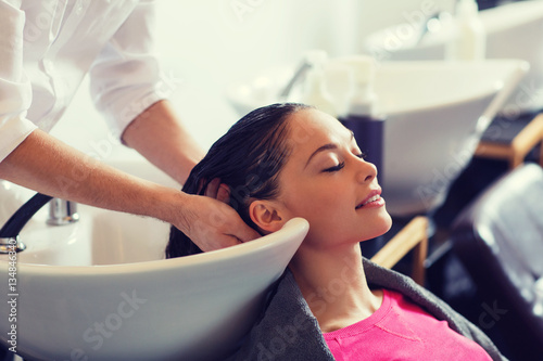 happy young woman at hair salon