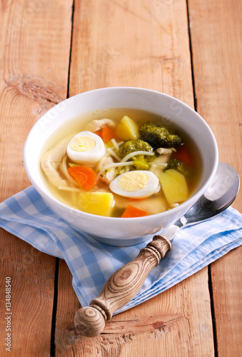 Chicken noodle soup with broccoli and quail eggs