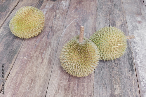 Wallpaper Mural durian ripe fruit  which has thorn on the wood board background. Torontodigital.ca