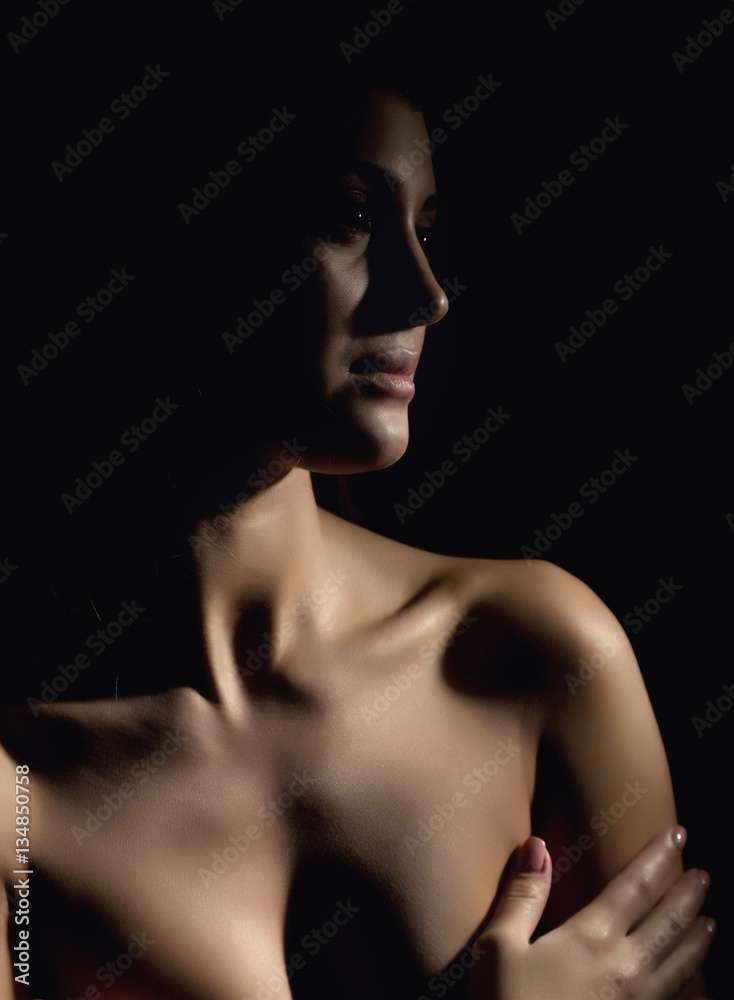 silhouette of nude beautiful asian woman on black background