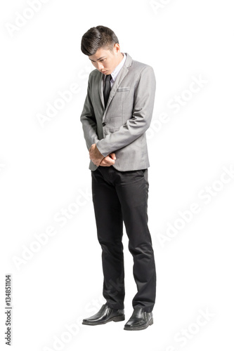 Portrait of a regret young business man. Isolated full body on w