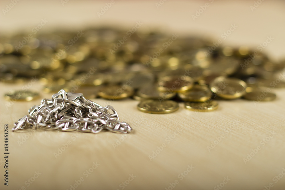 Close up of a digital scale and some gold coins. Silver and gold necklaces by the side. At the jewelers. Pawn shop. Silver and gold on the table. Close up of a digital scale and some gold coins. Silver and gold necklaces by the side. At the jewelers. Pawn shop. Silver and gold on the table.