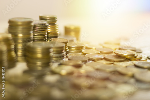 Close up of some gold coins. At the jewelers. Pawn shop. Money on the table. Lensflare in the background.