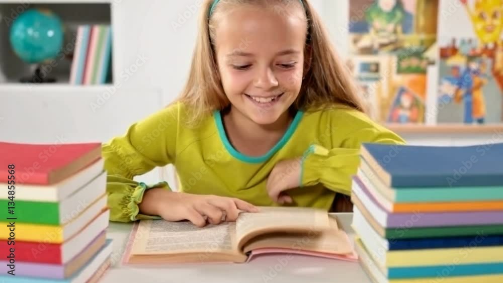 Little girl enjoy reading her book and giggling - closeup, slow dolly motion Little girl enjoy reading her book and giggling - closeup, slow dolly motion