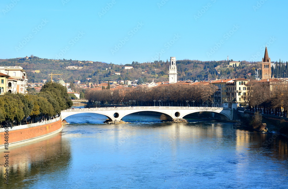 The city of Verona with the river bridge, panorama of the city and the hills