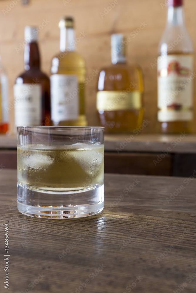 glass with whisky on wooden table glass with whisky on wooden table