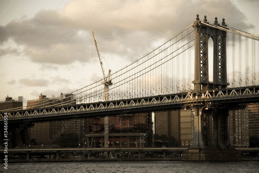 Manhattan bridge over the river and the city in vintage style, New York