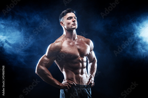 Strong bodybuilder man with perfect abs, shoulders,biceps, triceps, chest.