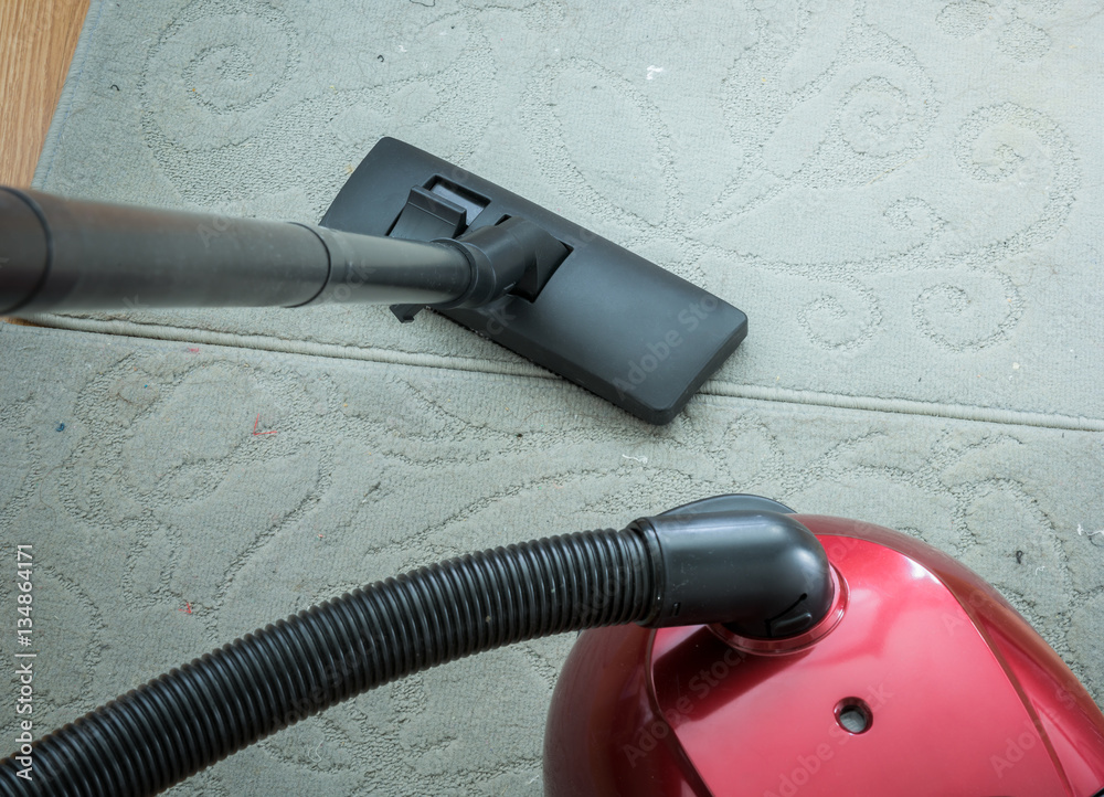 Vacuum cleaner on a gray carpet