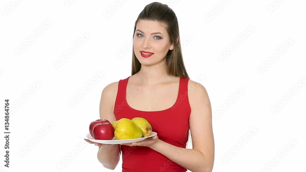 woman holding plate with red Apples and pears and smiling woman holding plate with red Apples and pears and smiling