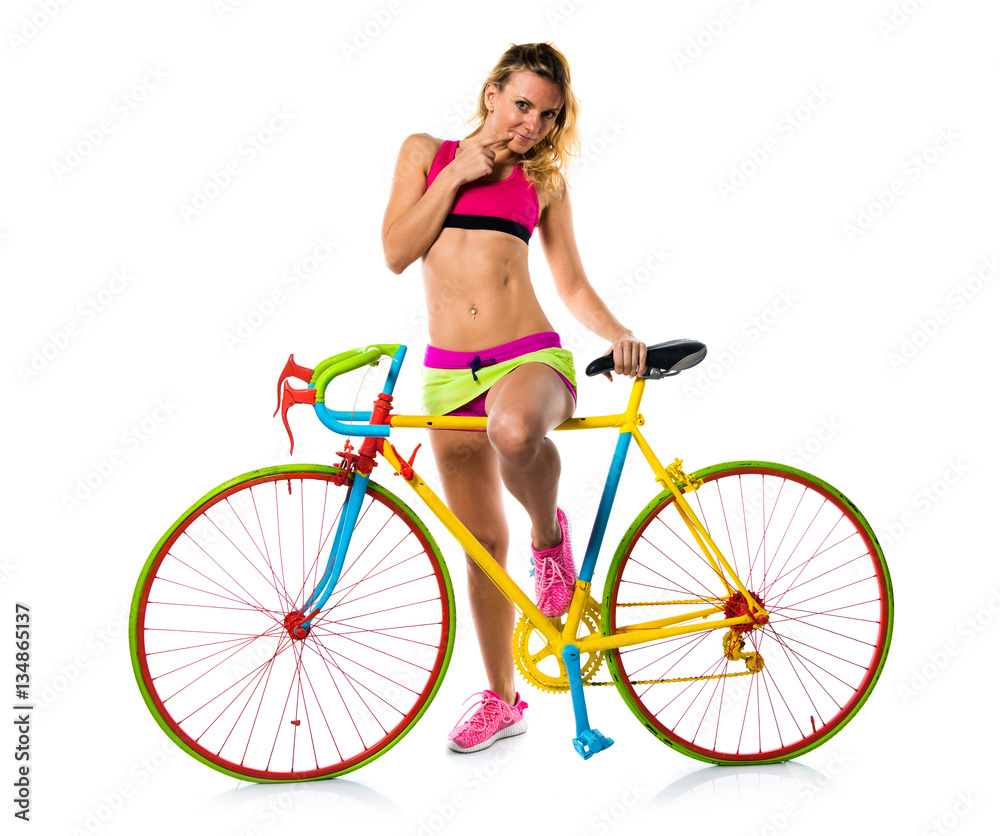 Beautiful blonde woman with colorful bike