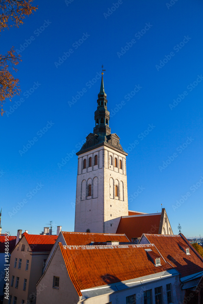 Sunny summer day and Old Medieval Former St. Nicholas Church - Niguliste In Tallinn, Estonia