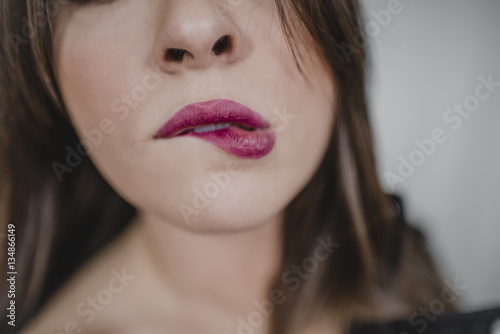 Woman biting her lip photo