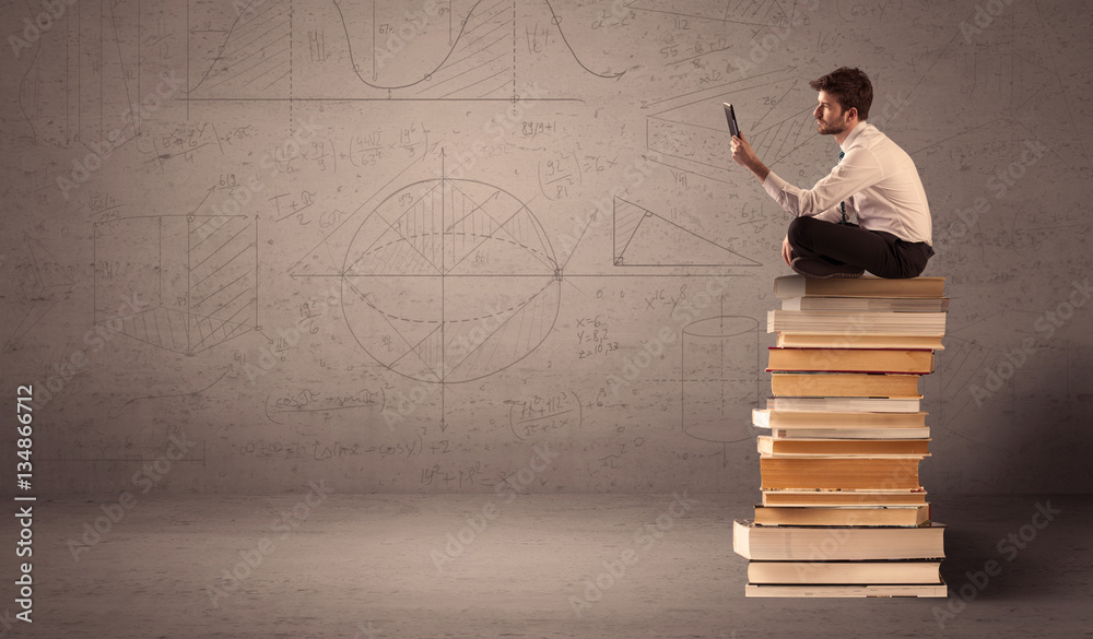 Businessman with tablet sitting on books Businessman with tablet sitting on books