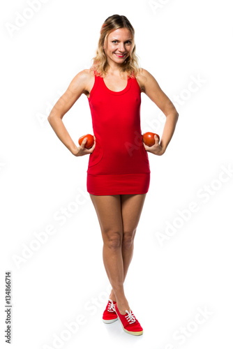 Beautiful blonde woman holding tomatoes © luismolinero