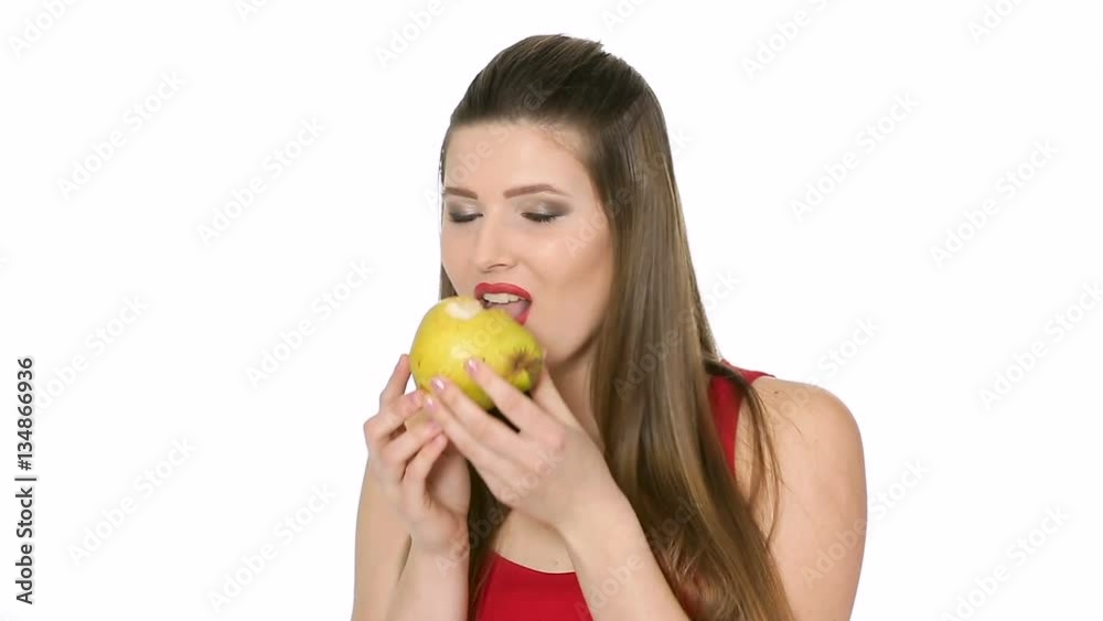 beautiful girl eats ripe pear on white background beautiful girl eats ripe pear on white background