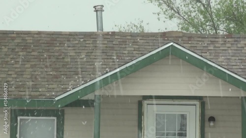 Hail Blasting Roof of House photo
