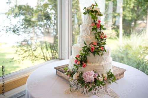 Decorated wedding cake on wooden cake stand
