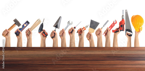 Hands holding tools on white background