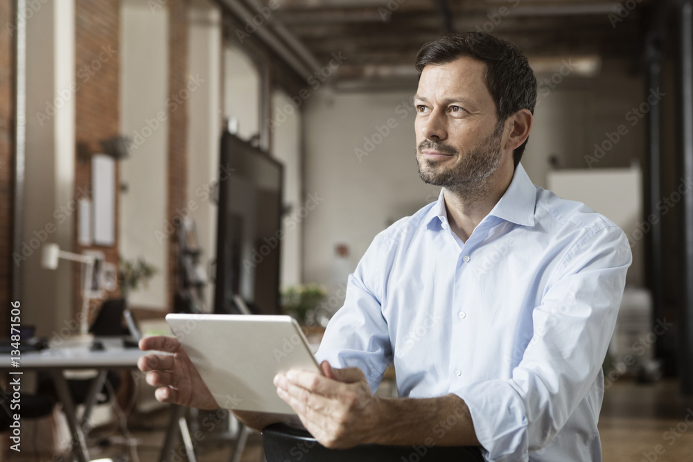 Businessman using tablet in office Businessman using tablet in office