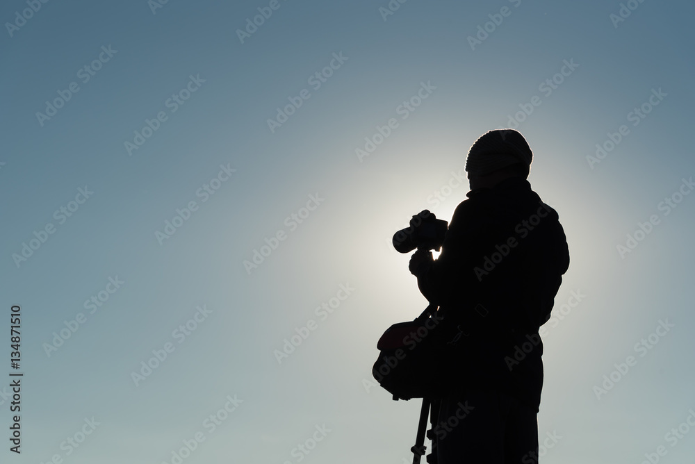 Silhouette of photographer taking photos. Filter effect style