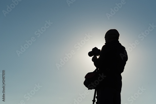 Silhouette of photographer taking photos. Filter effect style