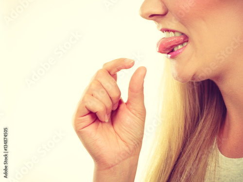 Tapeta Woman having something disgusting on tongue
