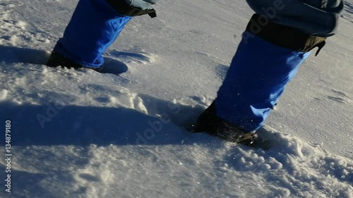 Close up - hiking through deep snow in slow motion