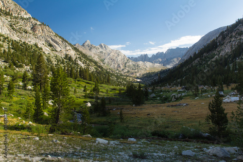 Wide meadow and valley under tall cliffs in the high sierra