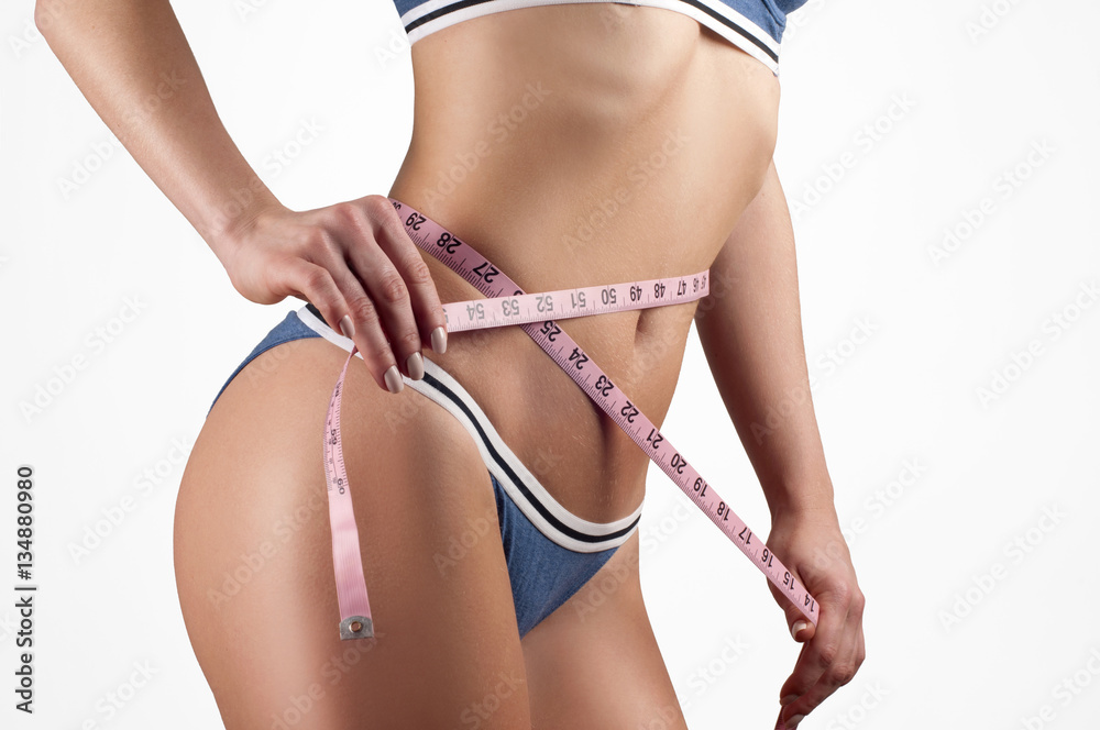 Woman measuring waistline, fitness and diet concept