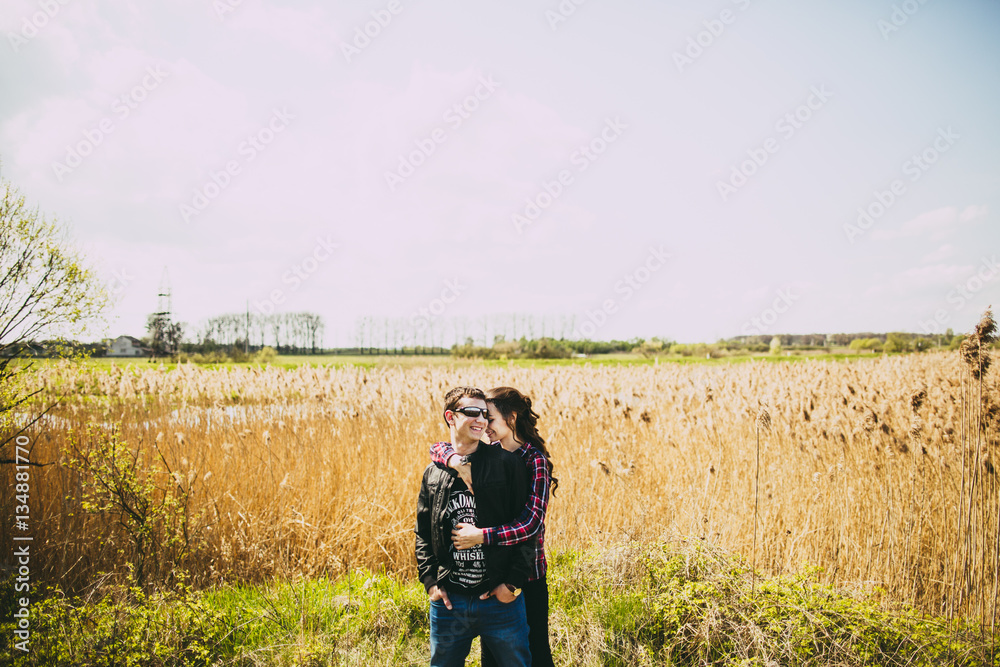 Portrait of a young couple on a background of reeds