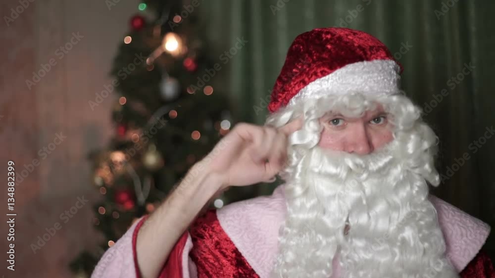 Closeup portrait of Santa Claus spinning finger to his temple, new year, christmas Closeup portrait of Santa Claus spinning finger to his temple, new year, christmas