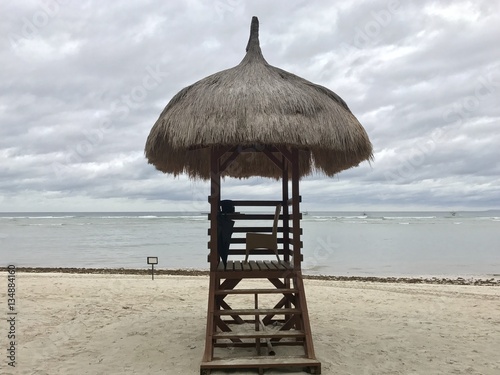 A lifeguard hut with sea in background on a cloudy day photo