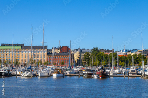 Scenic summer view of the Old Port pier architecture with ships, yachts and other boats in the Old Town of Helsinki, Finland
