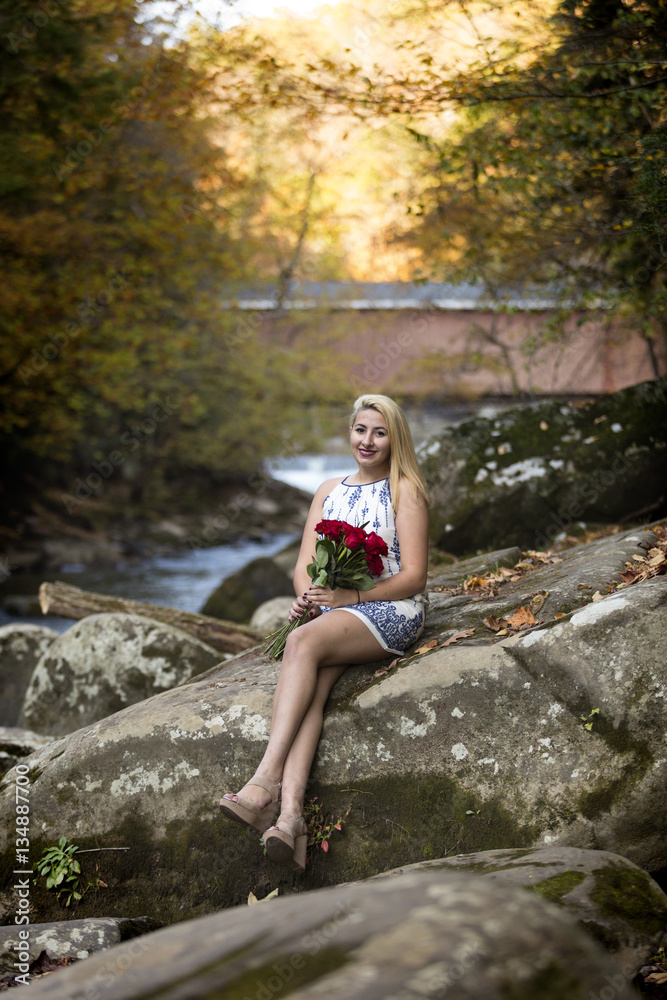 High School Senior Girl teenager holding red roses smiling High School Senior Girl teenager holding red roses smiling