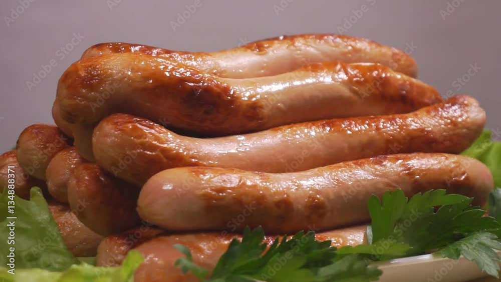 Grilled sausages on white plate. Grilled sausages and salad. Grilled sausages on white plate. Grilled sausages and salad.