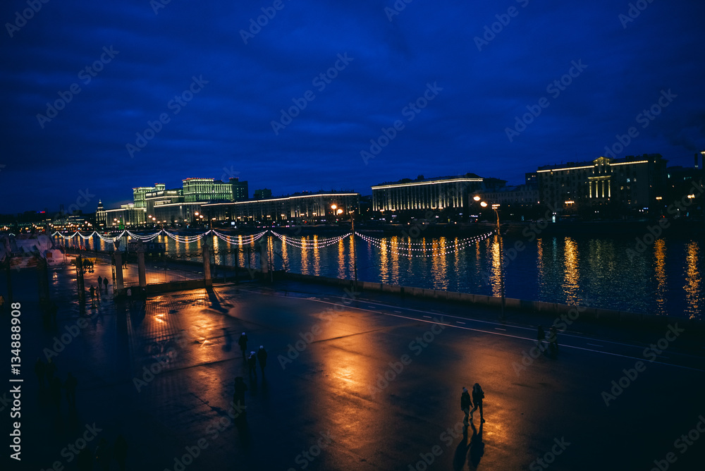 Moscow, Russia. Night cityscape with  bridge and Moscow river. Color bars on the headlights. Slow shutter speed