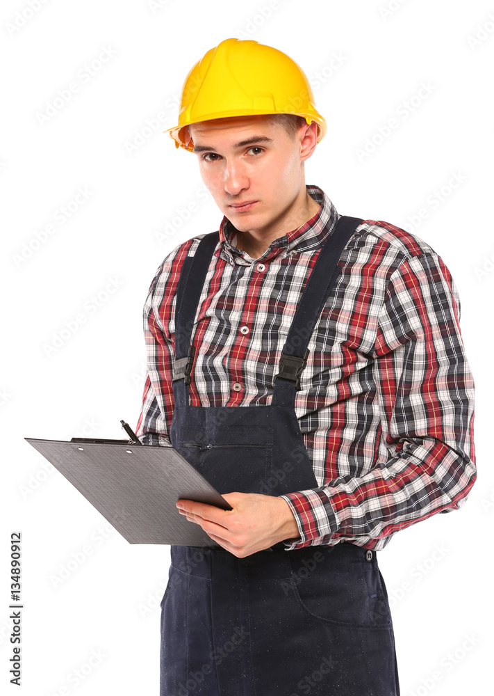 young worker with yellow helmet and gloves, writes in the book young worker with yellow helmet and gloves, writes in the book