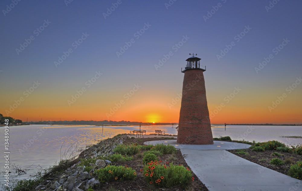 Dawn view over Lake Toho (Lake Tohopekaliga) in Kissimmee Florida including walkway and mini lighthouse. Dawn view over Lake Toho (Lake Tohopekaliga) in Kissimmee Florida including walkway and mini lighthouse.