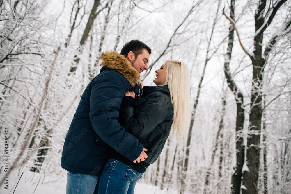 Winter. Cheerful young couple having fun in the snow. Winter love story. Winter. Cheerful young couple having fun in the snow. Winter love story.