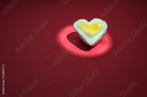 Egg heart on red. Romantic background concept