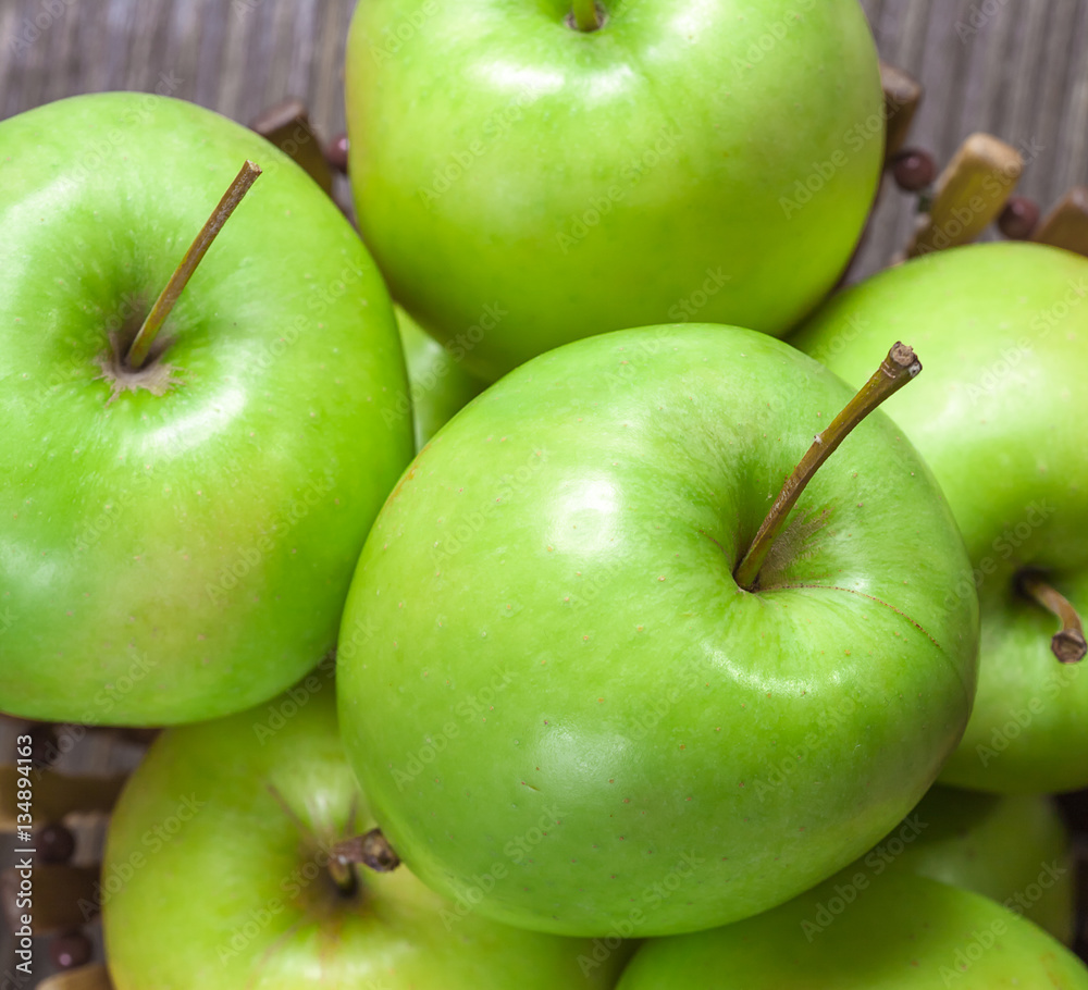 ripe green apples and apple slices on wooden gray background ripe green apples and apple slices on wooden gray background