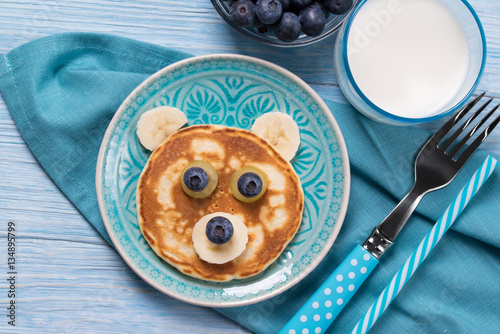 Funny pancake in a shape of teddy bear, food for kids idea, top view