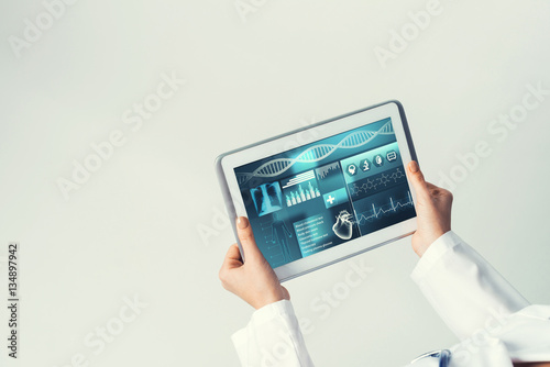 Close of female doctor hands working with tablet pc computer