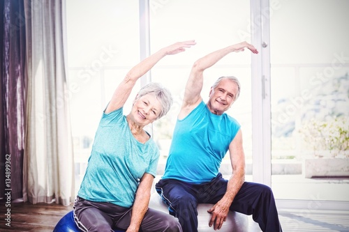 Portrait of happy senior couple exercising