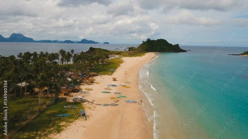 Aerial view of beautiful tropical island with sand beach. Tropical lagoon with turquoise water and yellow sand. Seascape: Ocean and a beautiful beach paradise. Beautiful view of a nice tropical beach Aerial view of beautiful tropical island with sand beach. Tropical lagoon with turquoise water and yellow sand. Seascape: Ocean and a beautiful beach paradise. Beautiful view of a nice tropical beach