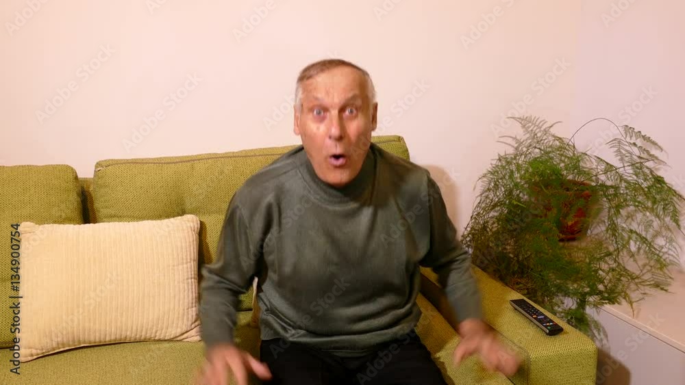 old man watching football on tv, the team is winning old man watching football on tv, the team is winning