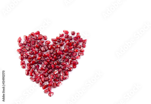 Juicy sweet delicious pomegranate seeds heart isolated on white background, I love you concept, valentine's day