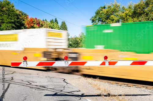 Obraz na plátně Goods Train Loaded with Containers in Motion at a Level Crossing.
